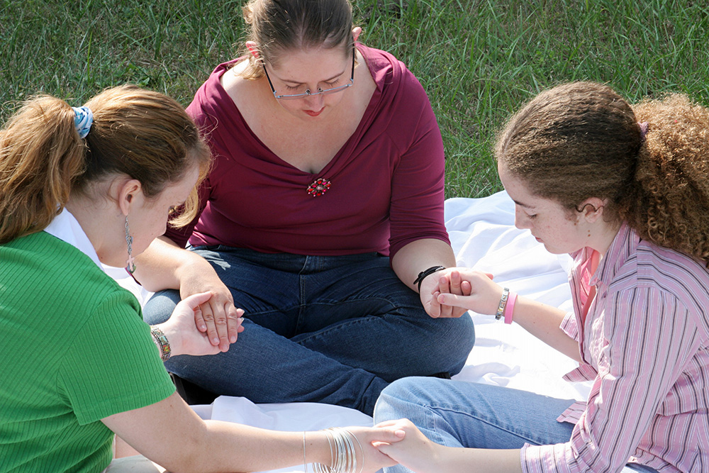 Christian High School students praying together